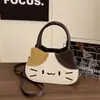 Bolsa de ombro de gatinho fofo em desenho animado, uma bolsa versátil para meninas, perfeita para estudantes, e uma bolsa transversal pequena casual
