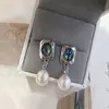 Nuevos pendientes de mujer de moda para comercio electrónico transfronterizo europeo y americano: perla natural, moda vintage popular, aretes creativos para dama
