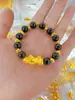 Tienda de oro con cuentas de transferencia de color esmalte de arena dorada antigua doble feliz cobre chapado en oro moda gato Joker ojo de gato pulsera al por mayor