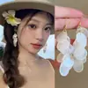 Pendientes de concha con borla de flor redonda de piedra ojo de gato aguja de plata, pendientes estilo vacaciones en la playa, pendientes de moda de alta gama para mujer