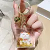 Figurita de Gato de la Suerte Llavero de Cristal para Niñas Llavero Creativo de Botella con Arena Líquida Lindo Artículo Pequeño para Puestos