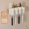 Dispensador de pasta de dientes blanco crema montado en la pared, Juego de vasos para cepillos de dientes colgantes sin perforaciones para baño
