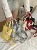Bolso de Mano Pequeño Texturizado de Moda Transfronterizo para Mujer 2026 Nuevo Bolso de Teléfono Móvil de Verano Estilo Coreano Bolso Cruzado Personalizado