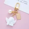 Chaveiro de Anjo Barroco Retrô Atacado Cupido Pérola Cabeça de Amor Pingente para Fone de Ouvido Chaveiro de Bolsa para Casal