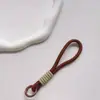 Correa de Muñeca Trenzada Estilo Ins Lanyard Nudado Cuerda Corta de Silicona Colgante Antiperdida para Teléfono Dopamina