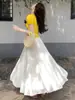 Falda blanca de gasa para mujer, nuevo modelo de verano 2026, de cintura alta, falda de línea A que estiliza, plisada, elegante, falda larga con bajo amplio