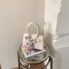 Bolsas Femininas Primavera 2026 Nova Moda Europeia e Americana Padrão Lichia Bolsa de Ombro Tendência Bolsa de Mão para o Trabalho Bolsas Femininas