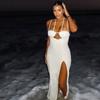 Falda irregular con abertura en la cadera de color sólido hueco estilo europeo y americano para comercio exterior, vestido largo ajustado sin espalda con cuello halter, moda para mujer
