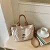 Bolsa de ombro feminina Shuai Mi Jia de grande capacidade, bolsa de mão para o trabalho, nova bolsa transversal simples para estudantes do início do outono de 2026
