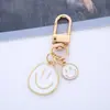 Llavero Creativo de Aleación con Goteo de Aceite Sonriente Corazón de Niña Llavero para Bolso Colgante Protector para Auriculares airpods