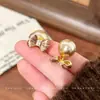 Pendientes de lujo ligeros estilo francés con diseño de lazo multiusos y cuentas, nueva colección 2026, pendientes de nicho de alta gama, accesorios versátiles