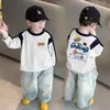 Camiseta de manga larga 100% algodón para niño, colección primavera y otoño 2026, estilo nuevo para niños mayores, camiseta base raglán para bebé, moderna
