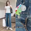 Producto de alta calidad: Pantalones de mezclilla Tencel de alta resistencia con bordado floral de 9 puntos en color azul brumoso, elásticos en cuatro direcciones, pierna recta adelgazante para principios de otoño