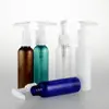 Botella redonda de hombro de 60 ml con bomba de tapón bomba de clip empaque cosmético emulsión desinfectante de manos botella vacía de PET para dividir