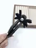 Perforación de sentido avanzado piel girasol clip perezoso temperamento medio pelo pinza de flor pelo trasero pinza de tiburón al por mayor