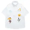 Camisas Retro Americanas Coloridas Bordadas com Flores de Manga Curta para Homens e Mulheres Verão 2026 Novas Camisas Casuais Xadrez Soltas