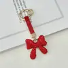 Chaveiro de laço com strass de argila criativo transfronteiriço, pingente de bolsa feminina moderno e de luxo leve, chaveiro de carro