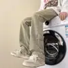Jeans retro americanos de 2026, lavados y desgastados, color barro amarillo, de botón, pantalones casuales rectos holgados, pantalones ligeramente acampanados de alta costura