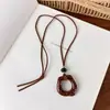 Cadena de suéter con lazo en forma de corazón de estampado de leopardo retro, un diseño único y elegante, con un collar largo geométrico de color café, creando un accesorio chic y atmosférico para mujer