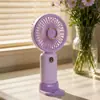 Ventilador de mano de escritorio de refrigeración para estudiantes de verano con base de soporte para teléfono, carga USB, ventilador pequeño, regalo fresco