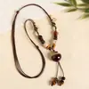 Collar con colgante de campana de mariposa de cerámica de estilo étnico retro para mujer, diseño nuevo y moderno, cadena larga para suéter, accesorios