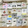 Colección Otoño 2026 Blanco Ins Versátil Lindo Dibujo Animado Nudo de Mariposa Borla Pendiente Lateral Estilo Chica Japonesa Calcetines de Media Pantorrilla