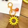 Chaveiro de girassol transfronteiriço, chaveiro de rosto sorridente, acessório fofo para bolsa, decoração pendurada no atacado, pingente de girassol