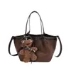 Bolso tipo cubo suave y cómodo para mujer, nuevo diseño de nicho estilo coreano 2026, adecuado para el trabajo y para llevar cruzado.