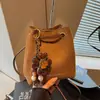 Bolsa de mão transfronteiriça de comércio exterior da moda para mulheres, nova bolsa de balde retrô de tecido escovado para o dia a dia, bolsa de ombro e transversal estilosa