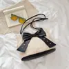Bolso de Hombro Tejido de Paja Elegante de Verano para Mujer 2026 Nuevo Estilo Temperamento Suave Bolso Cubo con Lazo Bolso de Hombro Versátil
