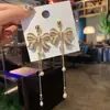 Aretes de borla con moño de diamantes completos, diseño de nicho, alta gama, elegantes, a la moda, aretes versátiles, venta al por mayor