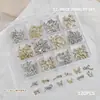 Accesorios para Uñas Artísticas Caja de 12 Compartimentos Mariposa Metálica Mixta Cuervo Corazón Cruz Cinta Lazo Decoración para Uñas de Forma Especial