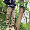 Pantalones de trabajo para exteriores estilo americano para hombre, adecuados para primavera y otoño, diseñados para senderismo y montañismo, con un corte holgado y recto, duraderos y con múltiples bolsillos, lo que los convierte en pantalones largos casuales
