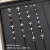 Nuevos y modernos aretes de cruz con diamantes completos Jiuhan para mujer, ear cuffs de acero de titanio de nicho, populares tachuelas de hueso de la oreja de alta gama
