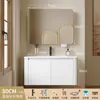 Tocador de baño engrosado y ahorrador de espacio con diseño en color crema, que cuenta con un lavabo redondeado, lavabo cerámico integrado y un lavabo de una sola pieza.