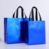 Bolsa no tejida láser transfronteriza en stock impermeable protección ambiental bolsa de compras de supermercado recubierta aluminizada bolsa de mano para tienda de ropa