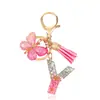 Moda Nuevo Rosa Pegamento Goteando Letra Llavero Lentejuelas Mariposa Borla Colgante Accesorios Colgantes de Bolso Venta al por Mayor