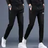 Calça esportiva casual masculina nova e moderna de outono, com bolsos, tamanho grande, calça jogger com zíper, calça de moletom de perna reta