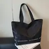 Bolsa de Lona Transfronteriza para Mujer, Gran Capacidad, Nueva Versátil Bolso de Hombro Otoño e Invierno 2026, Bolso Tote con Remaches de Mariposa para Estudiante Universitario