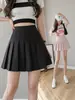 Saia plissada de cintura alta em estoque, saia curta feminina, saia de outono, estilo preppy, versão coreana, cor sólida, saia evasê anti-exposição, atacado