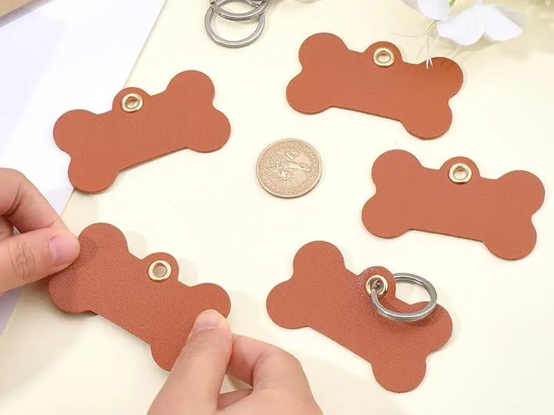 Step-by-step demonstration of terracotta-colored bone-shaped tags or decorative pieces being assembled with metal rings.