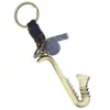 Llaveros de Cuero Tejido Nuevos Transfronterizos Europeos y Americanos, Colgantes Vintage de Instrumentos Musicales, Dijes para Bolsos, Tienda en Línea Regalos Pequeños al por Mayor