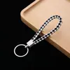 Llavero de cuerda de cuero colgante para coche accesorios cuerda de llave de cuerda de cuero tejido pu para empujar pequeño regalo fabricantes al por mayor