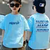Camiseta de algodón puro de manga corta para niños, nuevo estilo de verano con estampado de letras de dibujos animados, top holgado de moda para bebé de media manga