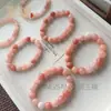 Venta al por mayor del fabricante Pulsera de Flor de Durazno Original de Xinjiang Natural Jade Oro Seda Jade Flor de Durazno Relleno Polvo de Cristal Rosa