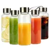 Botella de Agua Personalizada de Vidrio de Borosilicato Tapa de Acero Inoxidable Portátil a Prueba de Fugas Botella para Café Cold Brew Jugo de Frutas Botella de Vidrio para Jugo Té con Leche