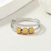 Moda europea y americana anillo de acero de titanio diseño de nicho corte hueco doble capa anillo de bola de acero móvil joyería de descompresión