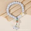 Pulsera de gato de la suerte chino con borlas y cuentas de garra de gato, joyería con texto, puesto de venta de pulseras en un lugar pintoresco, venta al por mayor