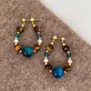 Pendientes de Cuentas de Ojo de Tigre Azul Aguja Plateada de Color Contrastante para Mujer Lujo Accesible Nicho Retro Otoño e Invierno Pendientes de Ojo de Tigre Maillard