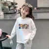 Camiseta de manga larga de algodón 100% para niñas con estampado de dibujos animados para primavera y otoño, adecuada para niños mayores y pequeños, camiseta básica versátil de cuello redondo estilo coreano
